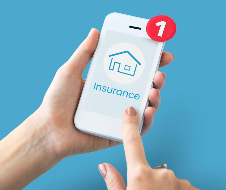 A person holding a smartphone with a home insurance app open on the screen and a notification icon showing one new alert, representing mobile access to insurance services.