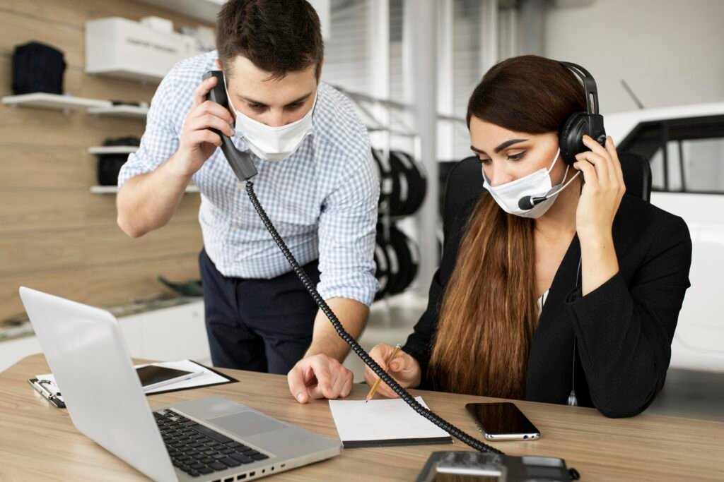 this image show how customer support employee work " one man on phn and other lady also on phn while noting"