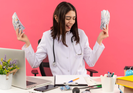 
A confident woman with curly brown hair holds a fan of cash in her left hand and points to it with her right hand. She stands against a light purple background.